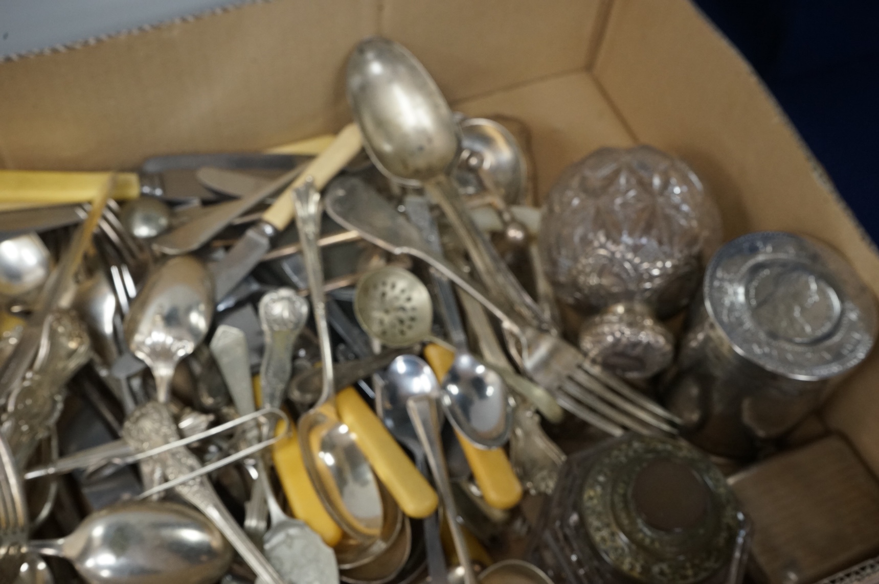 A pair of Victorian silver King's pattern table spoons by George Adams, London, 1858, a silver teaspoon, a mounted glass scent bottle, a silver cigarette case, a continental canister with inset coin lid, and assorted pla